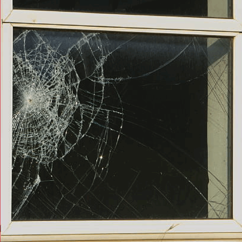 Window showing rotting, warping, and cracks